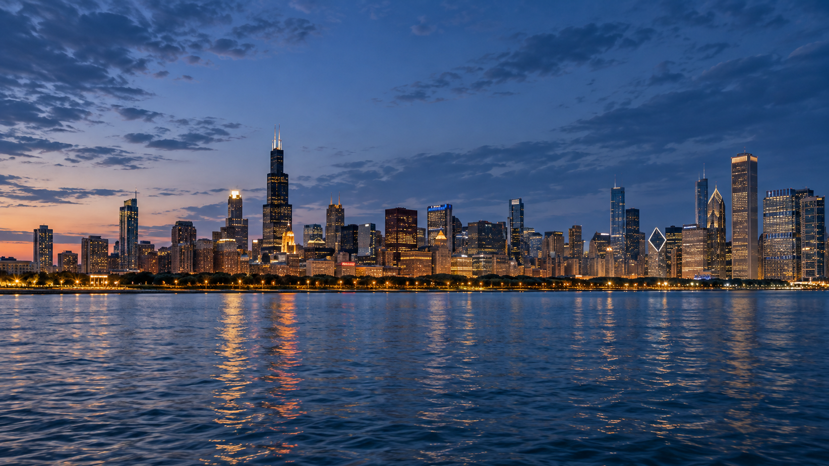 Chicago skyline illuminated at blue hour across Lake Michigan